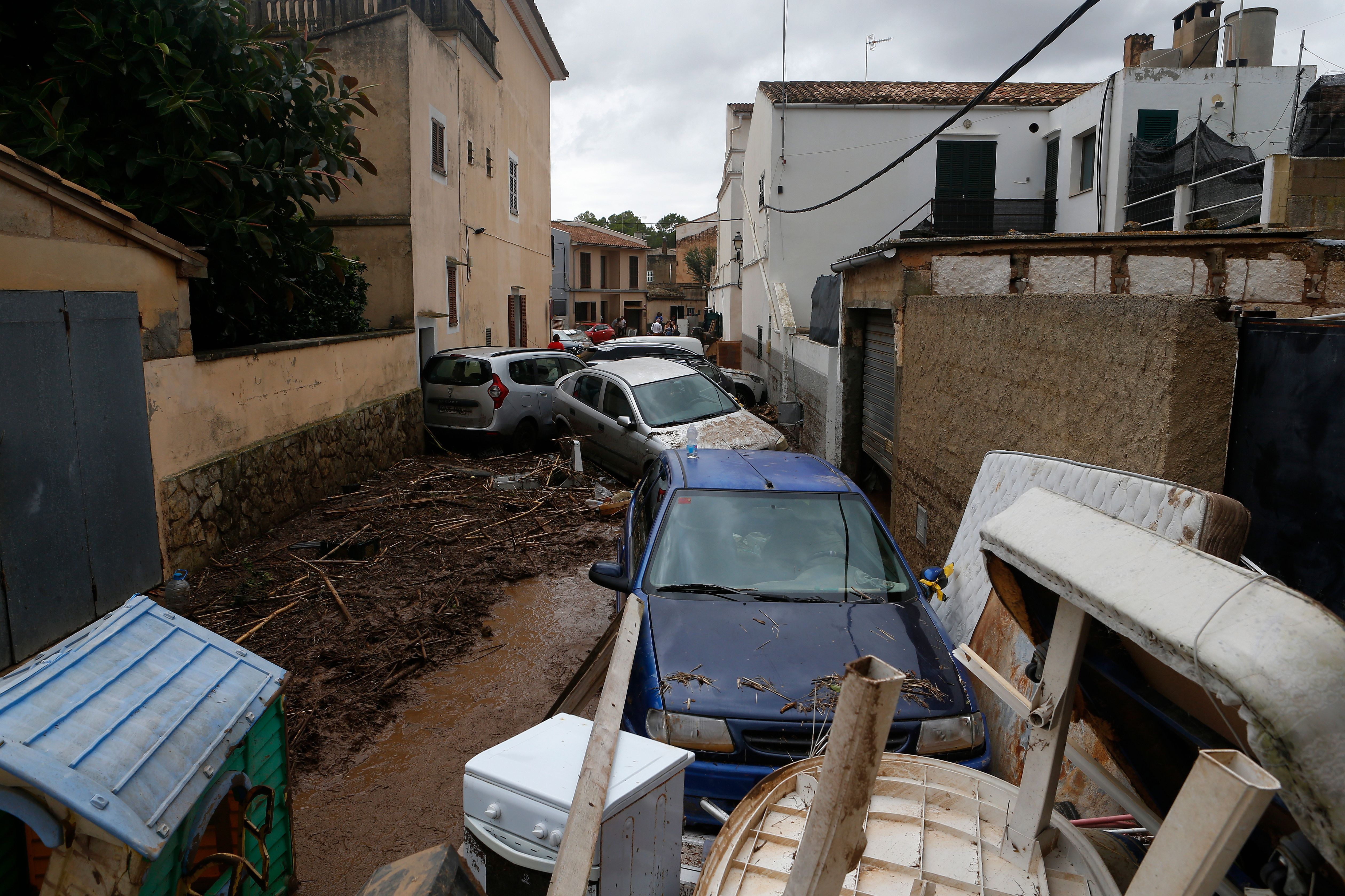 Vehicles and debris piled upon one another due to flash floods in Spain