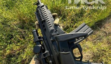 Ukrainian Army soldier takes a photo of his Italian Beretta ARX 160 assault rifle - with a scope and a suppressor.