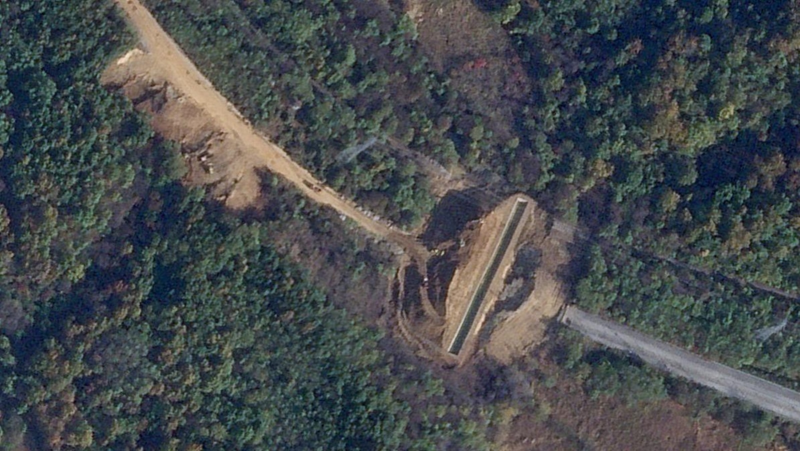 Satellite images show North Korea dug large border trenches after demolishing road, rail links