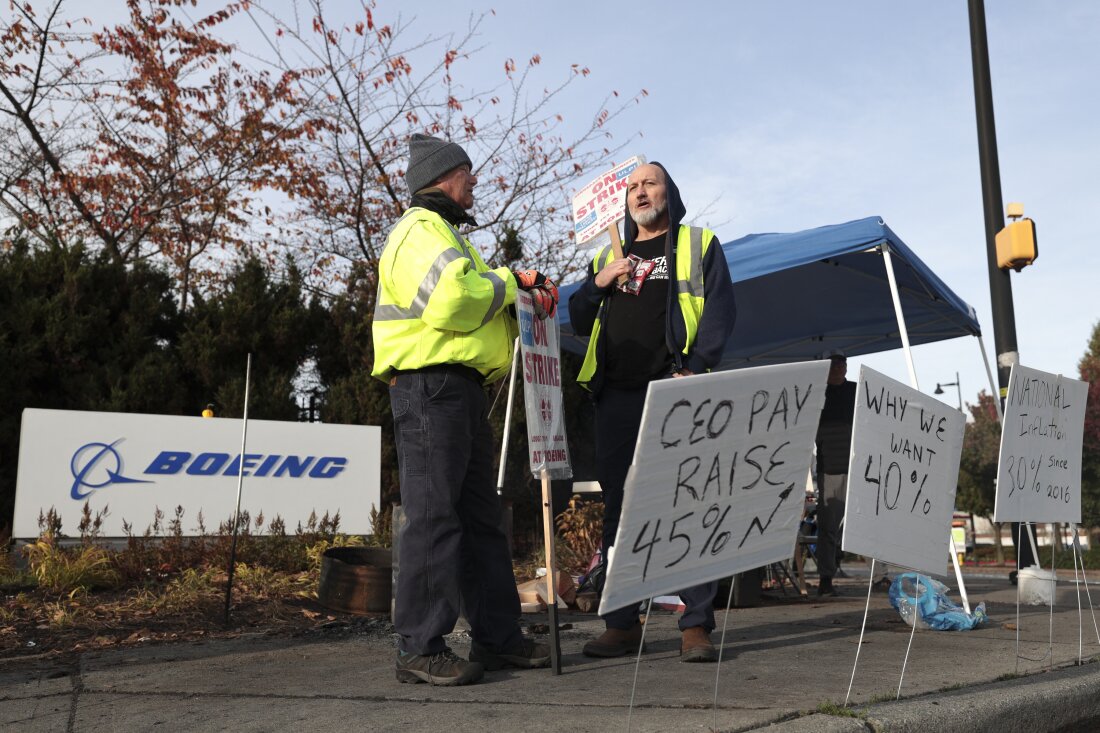 Striking machinists at Boeing picket outside the company's Renton Production Facility in Washington. Some 33,000 workers walked off the job in September demanding higher pay and better retirement benefits. Union members have voted down two previous contract offers from Boeing ahead of Monday's vote.