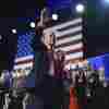 Republican presidential nominee former President Donald Trump waves as he walks with former first lady Melania Trump at an election night watch party at the Palm Beach Convention Center, Wednesday, Nov. 6, 2024, in West Palm Beach, Fla. 