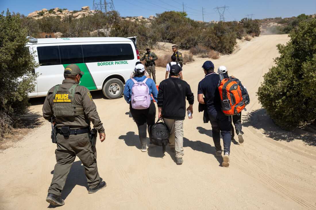 U.S. Border Patrol agents take asylum seekers into custody after they crossed a remote area of the U.S.-Mexico border near Jacumba Hot Springs, Calif., on Sept. 19, 2024. Trump's plan for mass deportations, if carried out, could deprive the economy of needed workers.