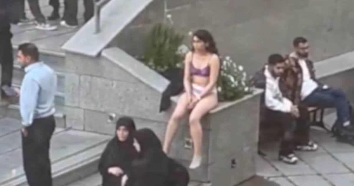 Iranian student strips in protest against assault by hijab enforcers.