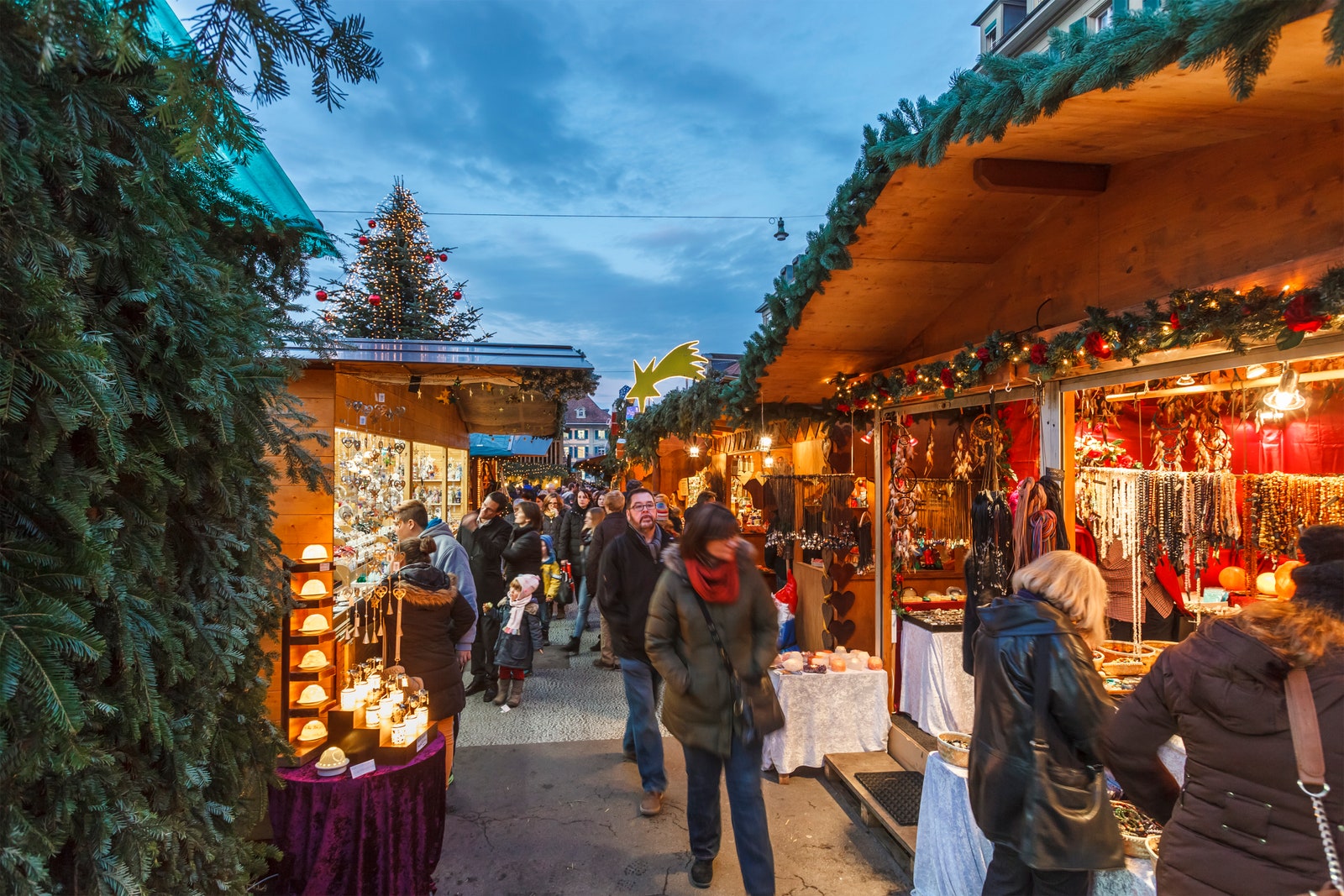 People in the Waisenhausplatz in the old town of Bern where one of the two traditional Christmas markets of the city is...