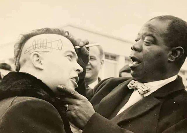 Louis Armstrong autographs a French punk’s head, 1961.